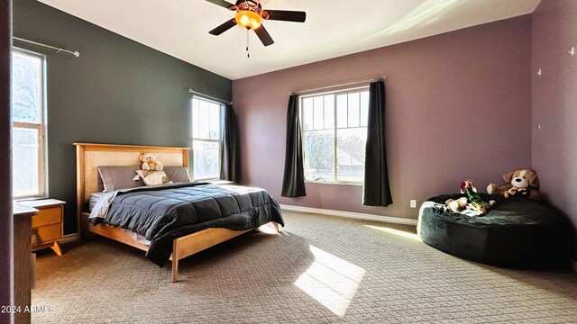 carpeted bedroom featuring ceiling fan and multiple windows