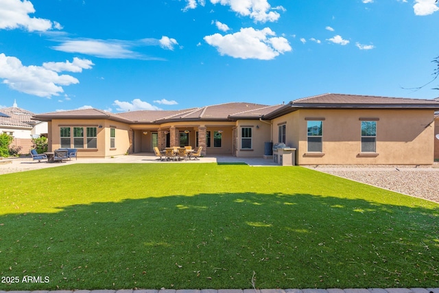 2285 E Mead Dr, Gilbert, AZ 85298 - rear view of property featuring stucco siding, a yard, and a patio area