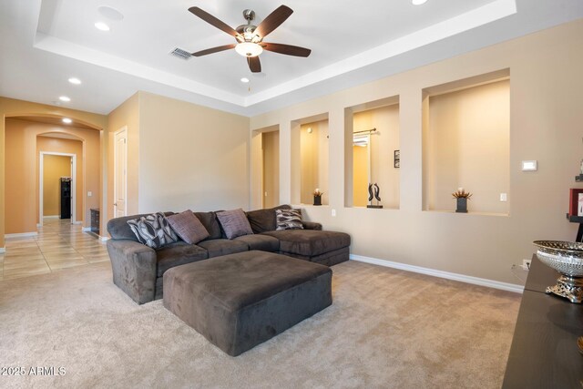 2285 E Mead Dr, Gilbert, AZ 85298 - carpeted living area with arched walkways, a ceiling fan, a tray ceiling, recessed lighting, and baseboards