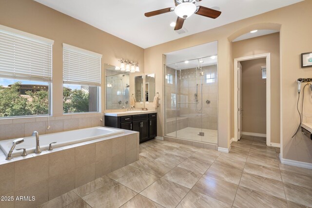 2285 E Mead Dr, Gilbert, AZ 85298 - full bathroom with vanity, a stall shower, a bath, ceiling fan, and baseboards