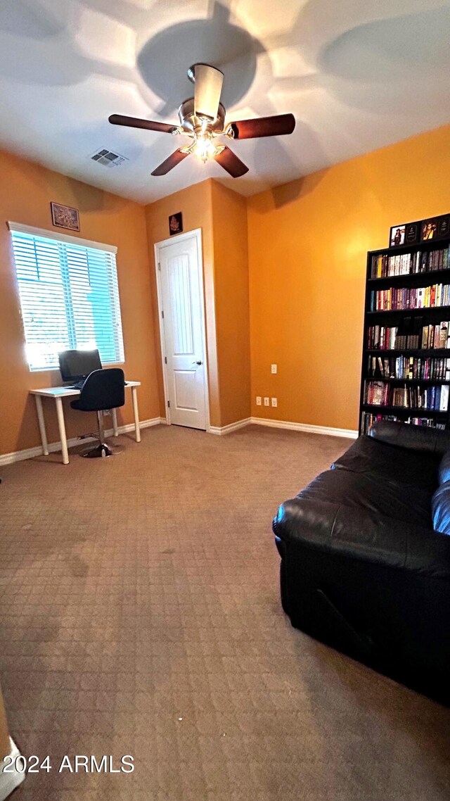 interior space featuring ceiling fan and carpet floors