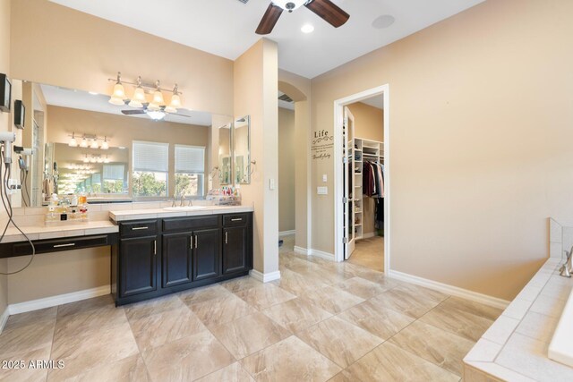 2285 E Mead Dr, Gilbert, AZ 85298 - full bathroom featuring vanity, a ceiling fan, a spacious closet, and baseboards