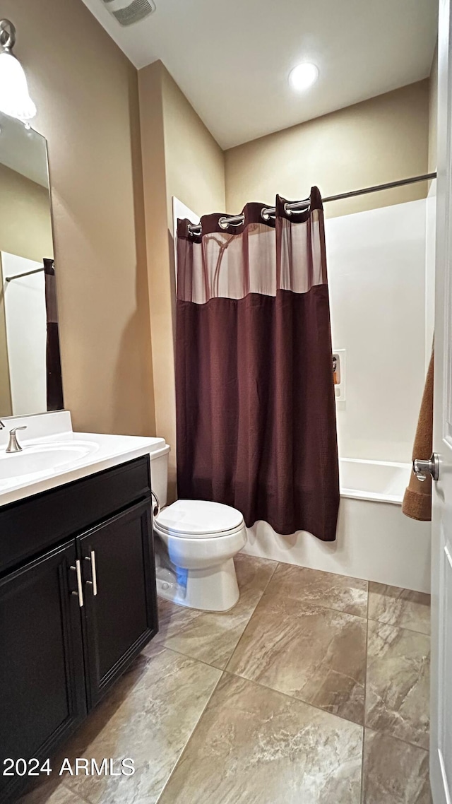 full bathroom with vanity, toilet, and shower / bath combo with shower curtain