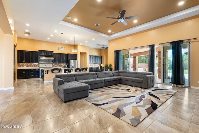 2285 E Mead Dr, Gilbert, AZ 85298 - living room featuring ceiling fan, recessed lighting, a raised ceiling, light tile patterned flooring, and baseboards
