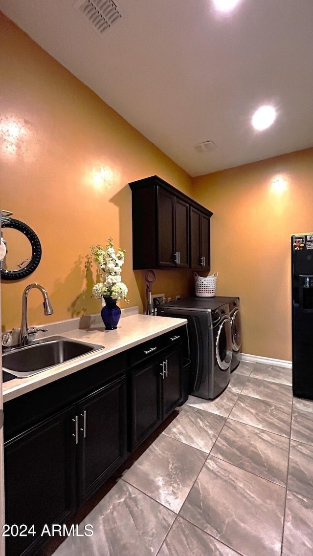 laundry room with cabinets, separate washer and dryer, and sink