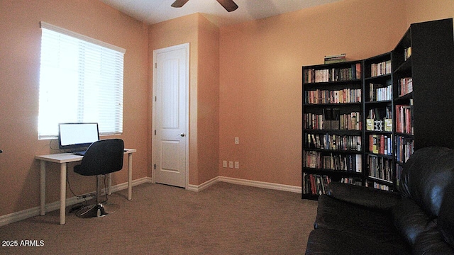 home office with carpet flooring, ceiling fan, and a healthy amount of sunlight