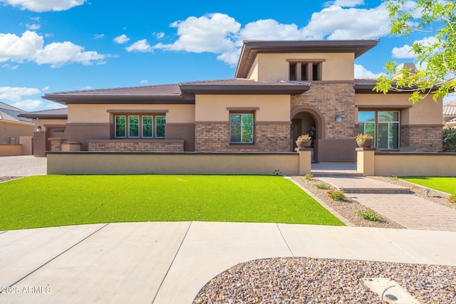prairie-style home featuring stucco siding and stone siding