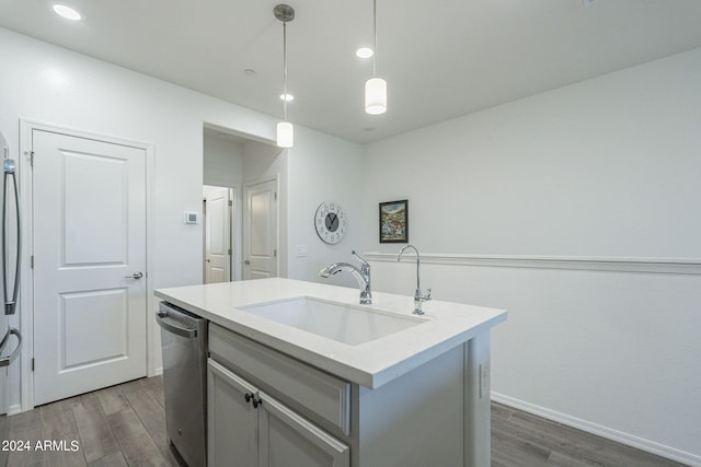 kitchen with dishwasher, dark hardwood / wood-style flooring, sink, pendant lighting, and a kitchen island with sink