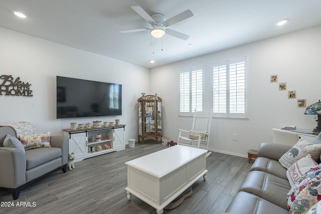 living room with ceiling fan and dark hardwood / wood-style floors