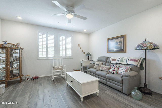 living room with dark wood-type flooring and ceiling fan