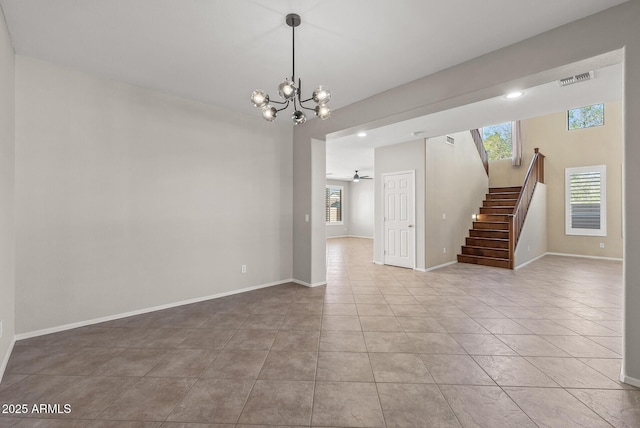 unfurnished room with visible vents, baseboards, stairs, tile patterned floors, and ceiling fan with notable chandelier