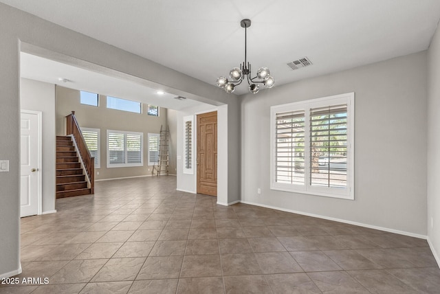 tiled spare room featuring visible vents, baseboards, an inviting chandelier, and stairway