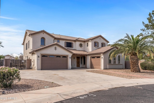 mediterranean / spanish house featuring fence, stucco siding, concrete driveway, a garage, and a tile roof