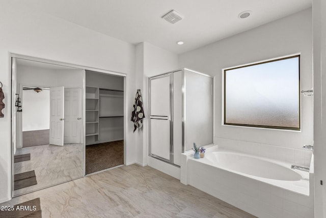 full bath with visible vents, a garden tub, marble finish floor, a shower stall, and a spacious closet