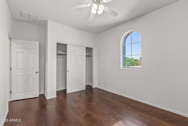 unfurnished bedroom with visible vents, ceiling fan, baseboards, a closet, and dark wood-style flooring