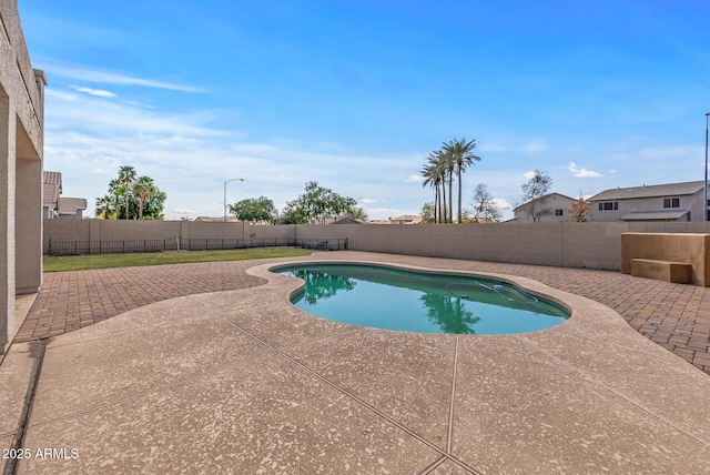 view of swimming pool featuring a fenced in pool, a fenced backyard, and a patio area