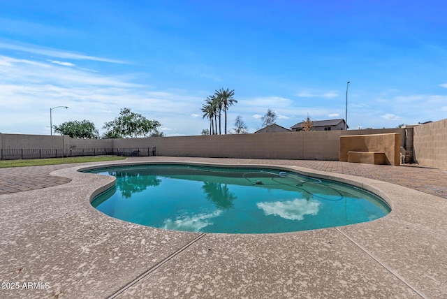 view of swimming pool featuring a patio area, a fenced in pool, and a fenced backyard