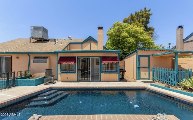 view of pool with cooling unit and a patio area