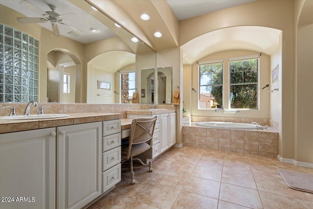 bathroom featuring vanity, ceiling fan, tile patterned flooring, and tiled bath