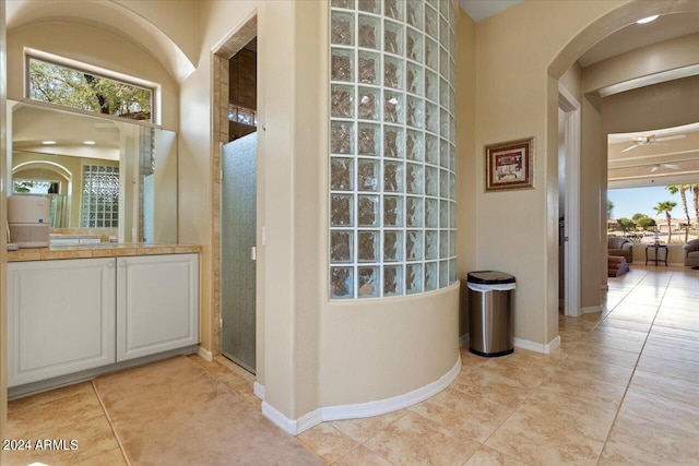 hall with light tile patterned floors and plenty of natural light