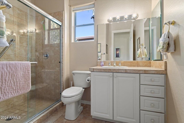 bathroom featuring vanity, toilet, and walk in shower