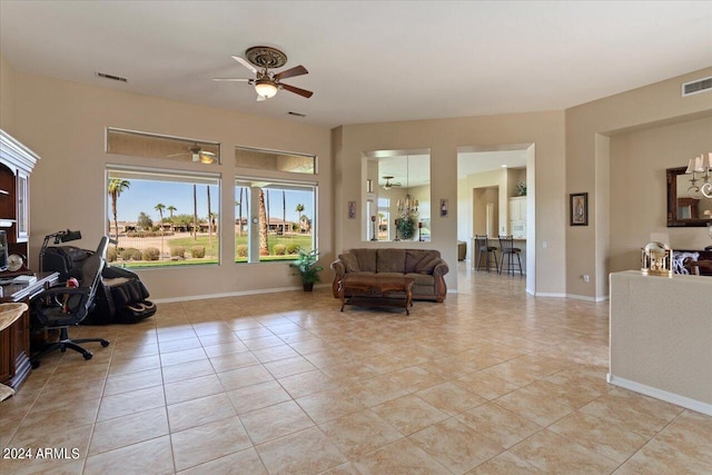 office with light tile patterned floors and ceiling fan with notable chandelier