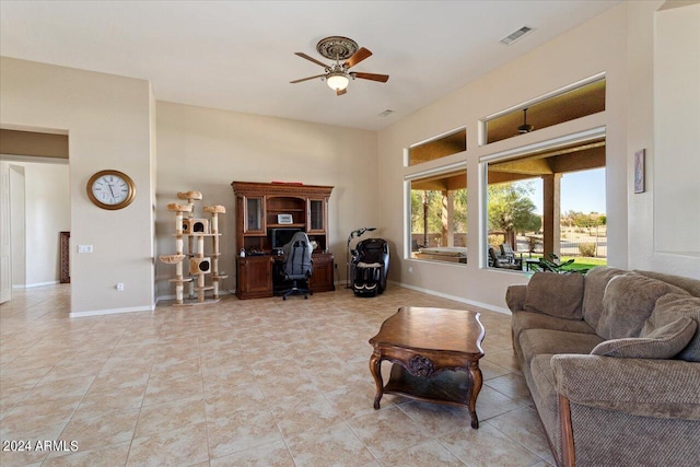 living room with light tile patterned floors and ceiling fan