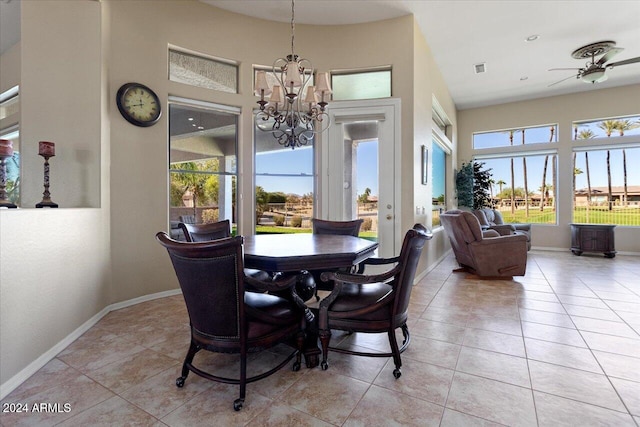 tiled dining room featuring plenty of natural light and ceiling fan with notable chandelier