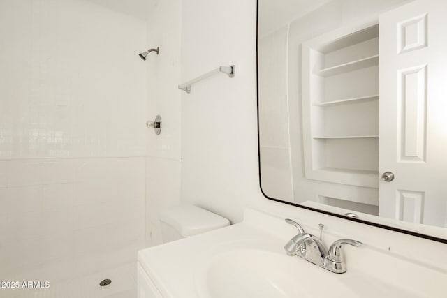 bathroom with a shower, toilet, and vanity