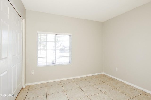 spare room featuring light tile patterned floors