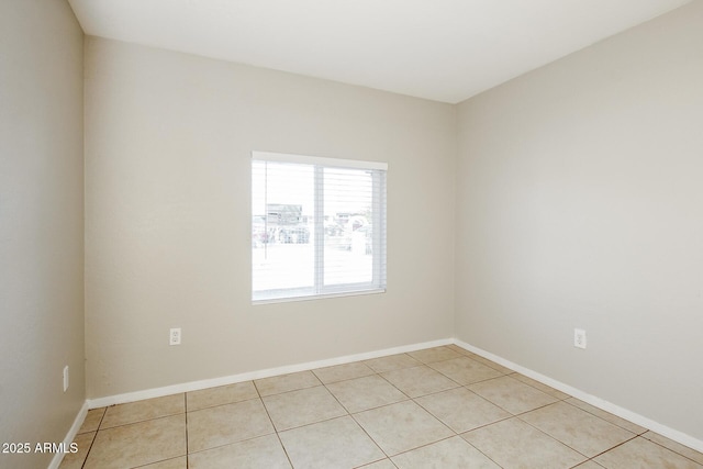 unfurnished room featuring light tile patterned flooring