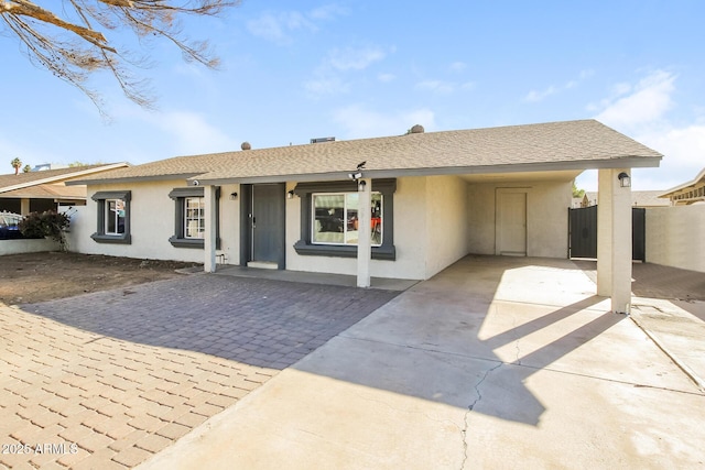 ranch-style house featuring a carport