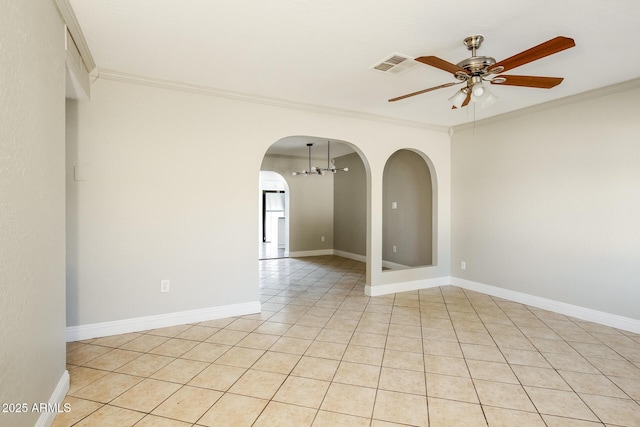 tiled empty room featuring ceiling fan and ornamental molding