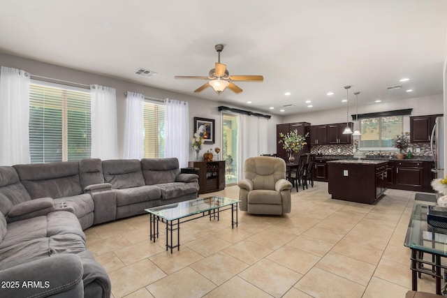 living room with ceiling fan and light tile patterned flooring