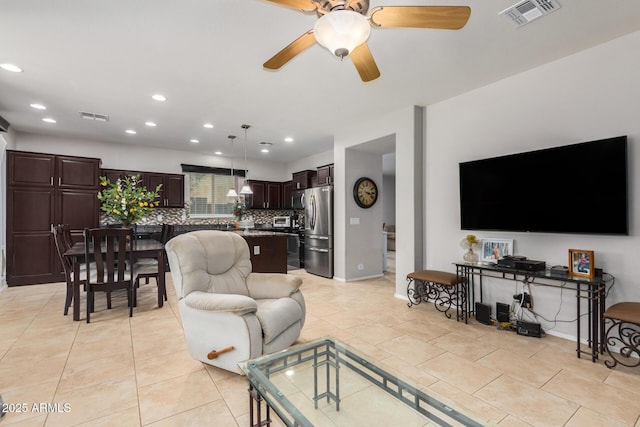 living room with ceiling fan and light tile patterned flooring