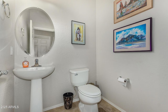 bathroom featuring sink, tile patterned floors, and toilet