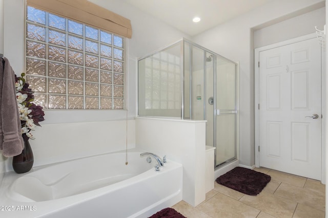 bathroom featuring plus walk in shower and tile patterned floors