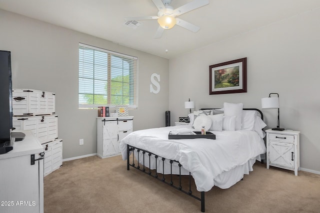 bedroom with ceiling fan and light carpet