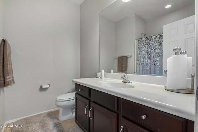 bathroom with toilet, vanity, and a shower with shower curtain