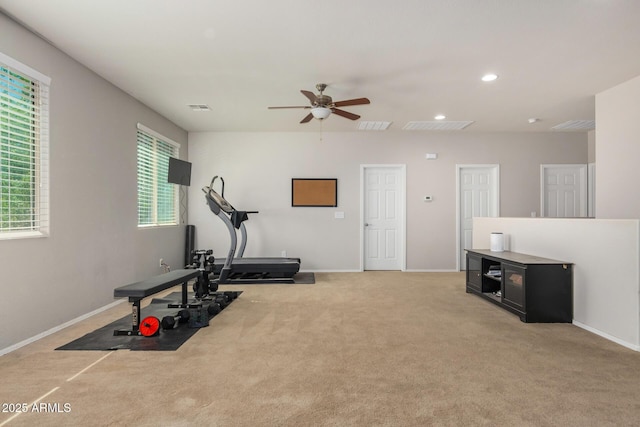 exercise area featuring light carpet and ceiling fan