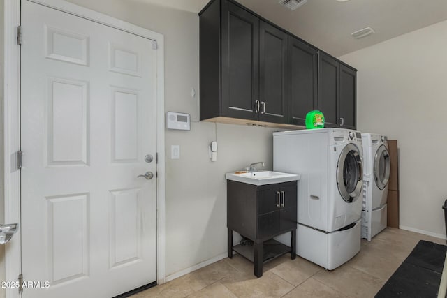 laundry area featuring washer and dryer, cabinets, sink, and light tile patterned flooring