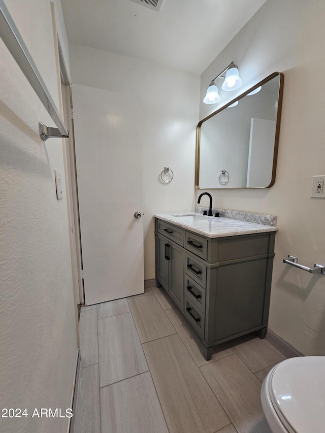 bathroom with vanity and toilet