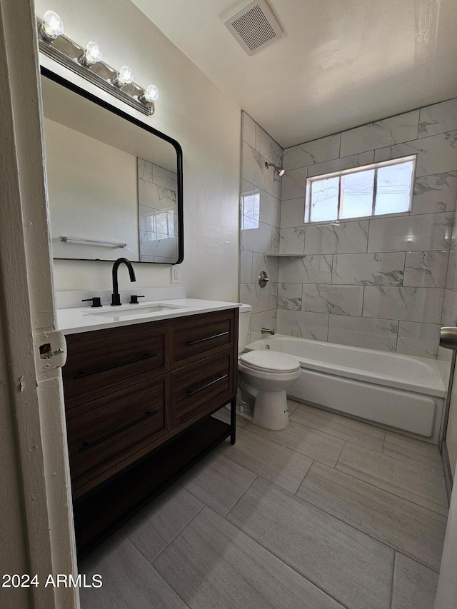 full bathroom featuring vanity, toilet, and tiled shower / bath combo