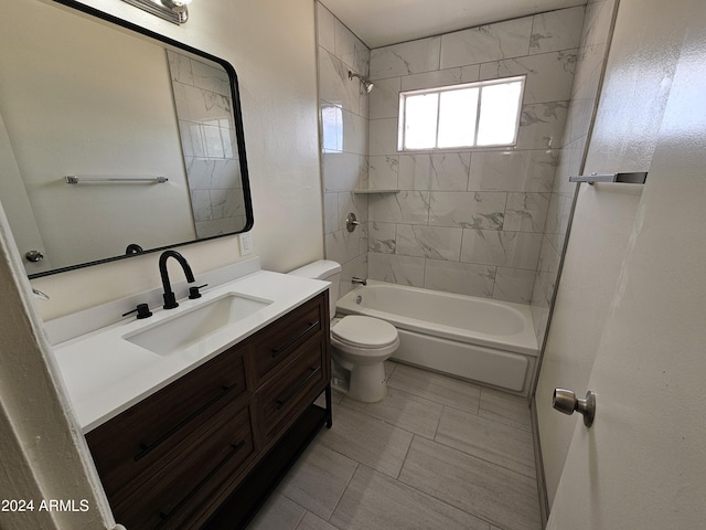 full bathroom featuring tiled shower / bath, vanity, and toilet