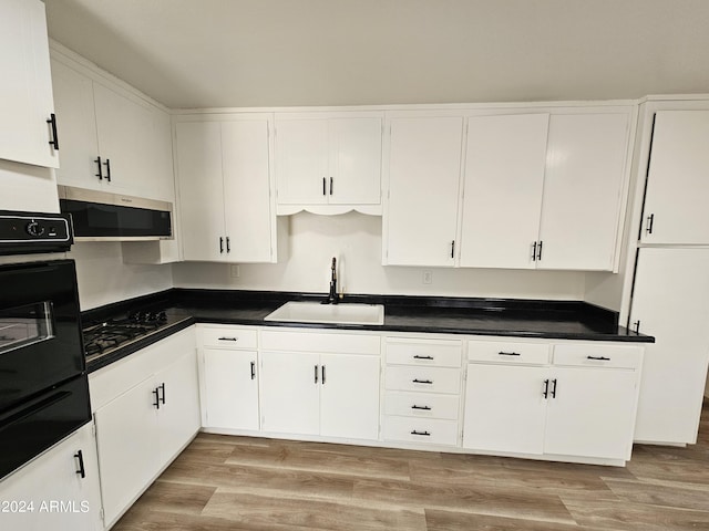 kitchen with white cabinetry, sink, light hardwood / wood-style flooring, and black appliances