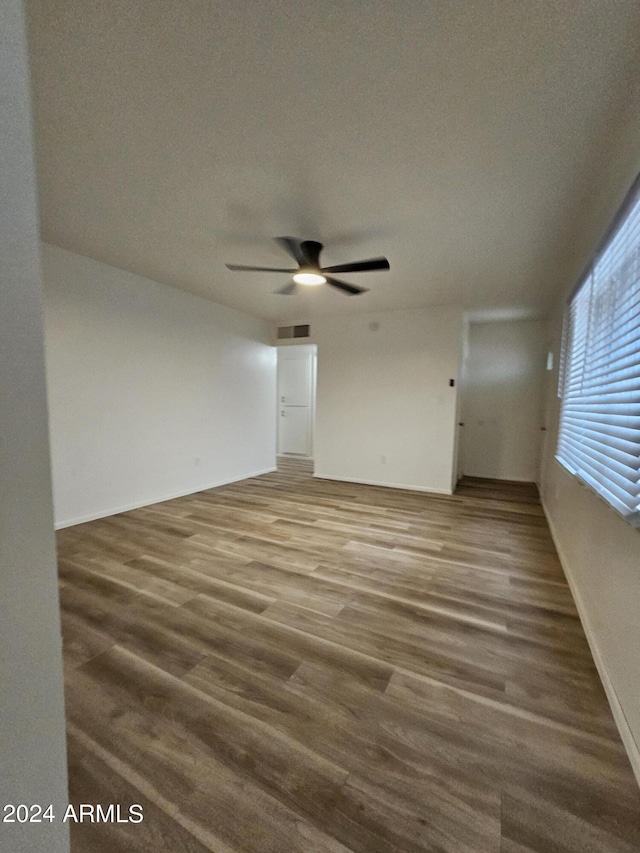 unfurnished room with ceiling fan and hardwood / wood-style floors