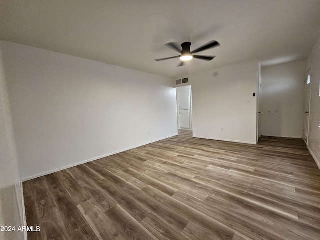 empty room with hardwood / wood-style flooring and ceiling fan