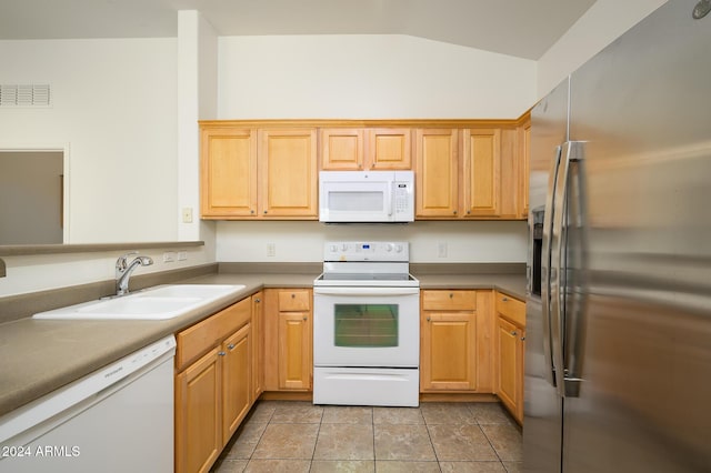kitchen featuring a sink, white appliances, visible vents, vaulted ceiling, and light tile patterned floors