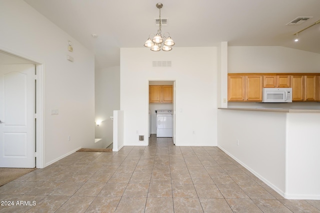 unfurnished living room featuring washer / dryer, visible vents, and a notable chandelier