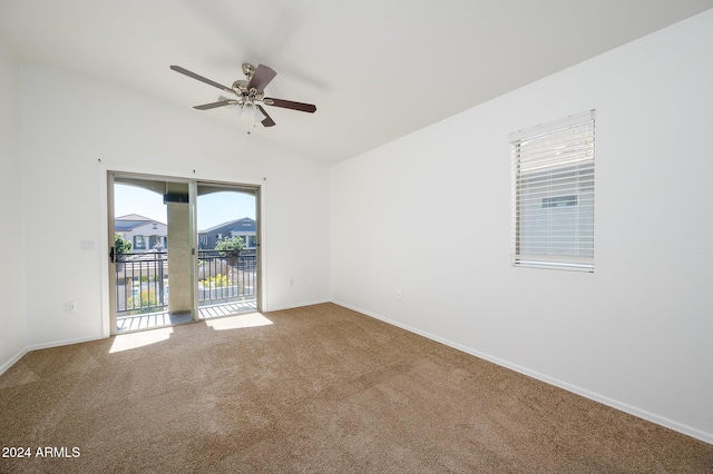 spare room with vaulted ceiling, baseboards, ceiling fan, and carpet floors
